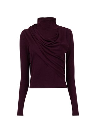 Langsleeve, coltrui in diep paarse stof. Kenmerkt zich door gedrapeerde details bij de halslijn en een slim-fit silhouet. Glad textuur overal.