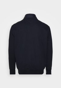 Svart sweatshirt med hög krage, långa ärmar och ribbade muddarna. Slät tyg med en enkel design och utan synliga mönster eller accenter.