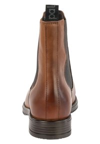 Botas Chelsea de cuero marrón con paneles laterales elásticos, una suela negra texturizada y una lengüeta en la parte trasera. Acabado suave con costuras sutiles.