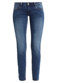 Jeans ajustados de mezclilla azul oscura. Diseño de cinco bolsillos, cierre de cremallera y trabillas para cinturón. Detalles deslavados en el frente que añaden textura.