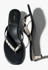 Fekete papucs kígyómintás pántokkal, lapos talppal, sima felülettel és minimalista kialakítással. Az "estro" márkalogó a talprészbe van nyomva.