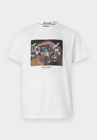 White cotton t-shirt featuring a colorful graphic print of a bar scene with cartoon characters. Text reads "WEEKEND OFFENDER" at the bottom.