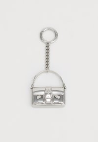 Silver keychain shaped like a handbag, featuring a structured design, shiny metallic surface, and a chain attachment.
