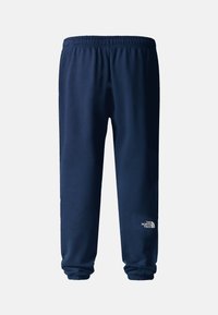 Pantalones de chándal azul marino hechos de una mezcla de algodón, con una cintura elástica y puños ajustados, y un detalle de logo blanco en la parte inferior de la pierna.