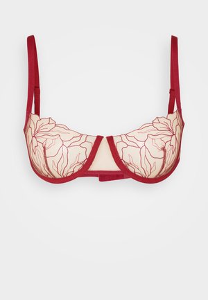 Soutien-gorge rouge avec des bonnets transparents ornés de broderies florales. Bretelles ajustables, soutien-gorge avec armatures et bande lisse. Pas de rembourrage.