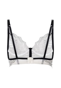 Bijela i crna čipkana bralette s valovitim rubovima, podesivim naramenicama i prednjim zatvaranjem. Ima prozirnu tkaninu i kontrastne obrube.