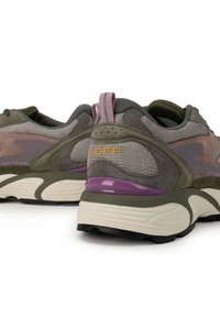 Dark green and gray sneakers with mesh and suede, featuring a purple heel accent and pink pull tab. Textured surfaces and pronounced sole design.