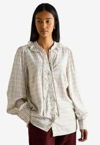 Hemd aus leichtem Stoff mit rüschigem Kragen, karierter Musterung in Pastellfarben und langen, leicht puffigen Ärmeln.