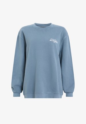 Sweatshirt surdimensionné bleu en coton, avec un col rond, des poignets côtelés et un petit logo blanc sur la poitrine.