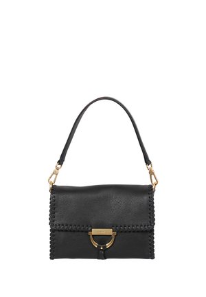 Black leather handbag with gold clasp and tassel detail, stitched edges, and a single shoulder strap against a white background.