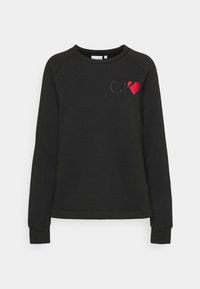 Felpa nera con collo a giro e maniche raglan. Logo "CK" ricamato e dettaglio cuore rosso sul lato sinistro del petto. Tessuto morbido.
