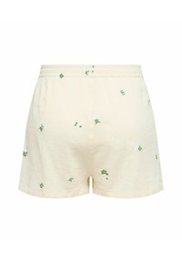 Shorts de color amarillo claro hechos de tejido Texturizado, con bordados florales en verde y blanco y una cinturilla elástica.