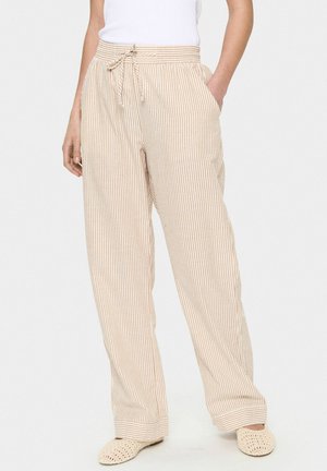 Gestreepte wijde broek in beige en lichtbruin, met een elastische tailleband met trekkoord en zijzakken. Zacht, lichtgewicht stof.