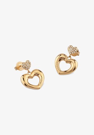 Goudkleurige hartvormige oorbellen met een holle center. De bovenkant heeft een kleinere hart die versierd is met heldere kristallen. Clip-on stijl.