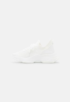 White athletic shoes with a knitted upper, rounded toe, and a cushioned sole. Features laces and a tab at the back for easy wear.