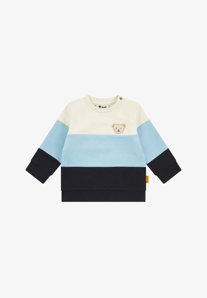 Sweatshirt en color block crème, bleu clair et marine. Il présente une appliqué d'ours et un bouton-pression au niveau du cou. En coton doux.