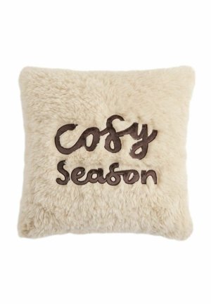 Square fluffy beige pillow with dark brown embroidered text "Cosy Season" in cursive and print style.