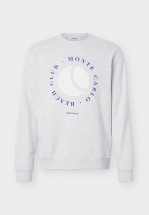 Svetlo siva dolg rokav z moderim krožnim napisom "Monte Carlo Beach Club" okoli bele grafike teniške žoge, spodaj logotip "Björn Borg".