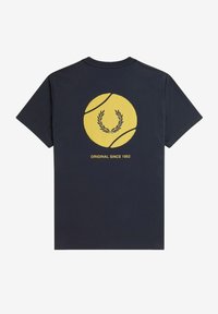 Camiseta de algodón en color azul marino con un gráfico de una pelota de tenis amarilla rodeada por una corona de laurel, y el texto "ORIGINAL DESDE 1952" debajo. Mangas cortas.