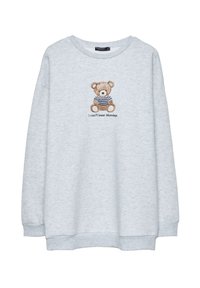 Lys grå sweatshirt med rund hals, prydet med en broderet bjørn i en stribet skjorte og teksten "Jeg kan ikke klare mandage" nedenfor.