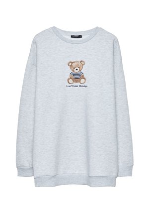 Hellgrau Sweatshirt mit Rundhalsausschnitt, das einen gestickten Bären in einem gestreiften Shirt zeigt, mit dem Text "Ich kann Montage nicht ertragen" darunter.