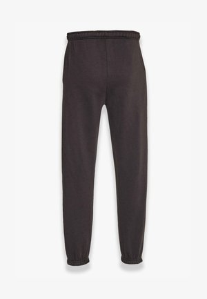 Pantalons de jogger noirs en tissu doux, dotés d'une taille élastique et de poignets élastiques, avec un design fuselé pour un ajustement près du corps.