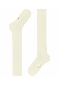 Cremefarbene Socken mit einer glatten Textur, ausgestattet mit einem gerippten Bündchen und einer verstärkten Ferse. Markenname "FALKE" in Braun gedruckt.