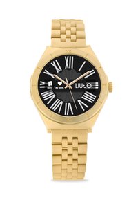 Gold-tone watch with a round black face, Roman numeral markers, and a linked metal strap. Features a heart rate and step count display.