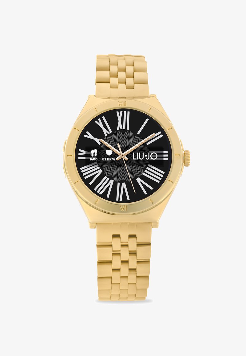 Gold-tone watch with a round black face, Roman numeral markers, and a linked metal strap. Features a heart rate and step count display.
