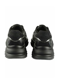 Black athletic shoes featuring a combination of suede and synthetic upper, textured sole, distinct branding at the heel, and reflective accents.
