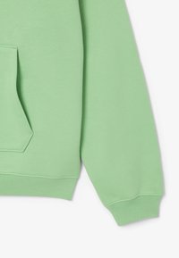 Ljusgrön sweatshirt med en känguruficka, ribbade ärmslut och nederkant. Tillverkad av mjukt tyg med en slät yta.