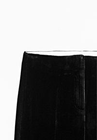 Black velvet pants featuring a straight cut, smooth texture, and side pockets, with a clean hemline and subtle sheen.