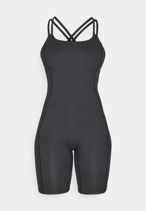 Bodysuit noir ajusté avec des bretelles croisées, fabriqué en tissu lisse. Présente un design épuré et des coutures contrastées sur les côtés.