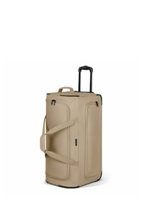 Beige Reisetasche mit Rollen, einem ausziehbaren schwarzen Griff, Seitengurten und Reißverschlüssen; glatte Textur und rechteckige Form.