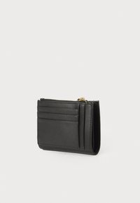 Black leather cardholder featuring a zip closure, multiple card slots, and a textured finish, showcasing a minimalist design.
