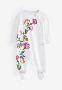 Tutina in cotone bianco con design floreali in rosa, viola e giallo. Chiusure a pressione lungo la parte anteriore; con piedi e fiocchetti rosa su ciascun piede.