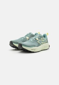 Light blue running shoes with a textured mesh upper, black rubber outsole, and yellow accents. Features cushioned Fresh Foam midsole.