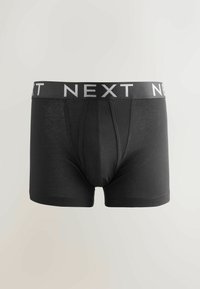 Calzoncillos de hombre negros con una tela suave, que cuentan con una amplia cintura elástica impresa con "NEXT" en blanco. Diseño de bolsa frontal incluido.