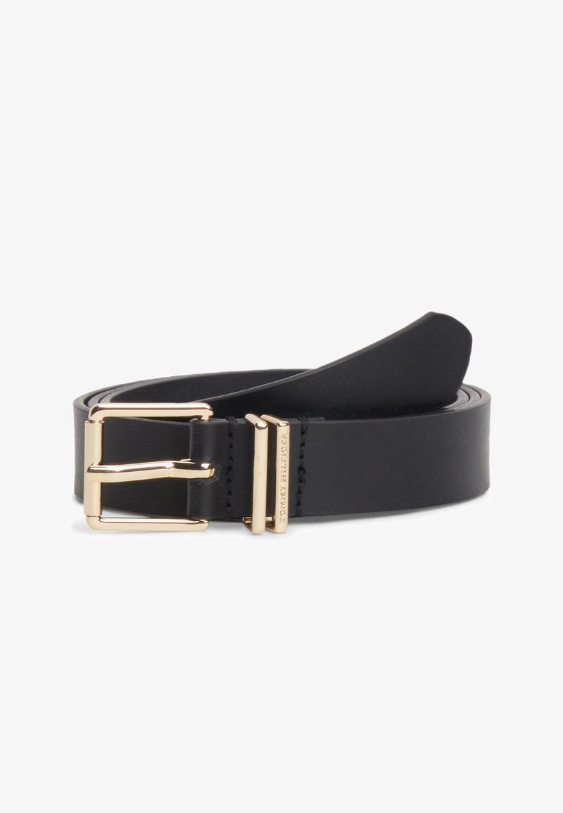 Ceinture en cuir noir avec boucle rectangulaire dorée et une boucle dorée gravée "Tommy Hilfiger", placée enroulée sur un fond blanc.