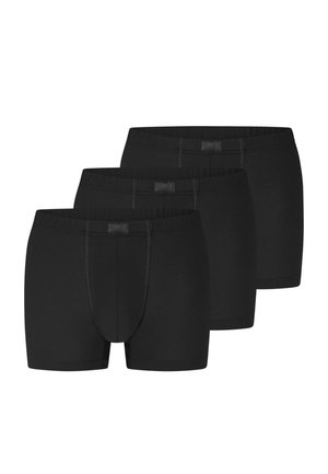 Tre boxer neri da uomo impilati, con cintura elastica e cuciture anteriori visibili.