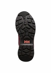 Suela de zapato de goma negra con un patrón de relieve que presenta formas hexagonales y triangulares. El logo "HH" está en rosa en el centro.