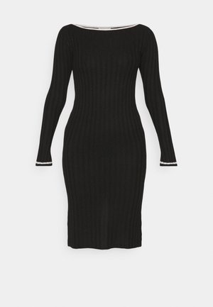 Black ribbed knit long-sleeve dress with a boat neckline and contrasting white accents on the sleeve cuffs. Form-fitting silhouette.