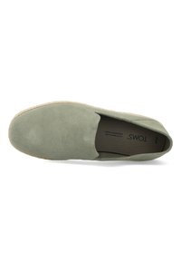 Green suede espadrille with slip-on design, elastic side, and rope detailing on the sole. Interior features branded insole.