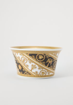 Keramikschale mit ausgestellter Form, verziert mit einem weiß-schwarzen Muster, das filigrane goldene Details und florale Motive aufweist.