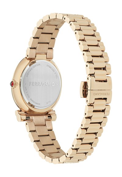 Arany tónusú rozsdamentes acél óra sima, kerek tokkal, zafír kristállyal, láncszemes szíjjal és piros díszítéssel a koronán.