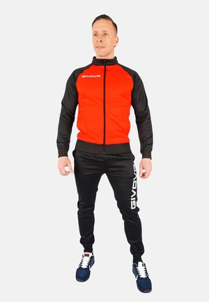Red and black tracksuit with a zippered jacket and matching pants. Features logo on the jacket and side of pants. Includes sneakers.