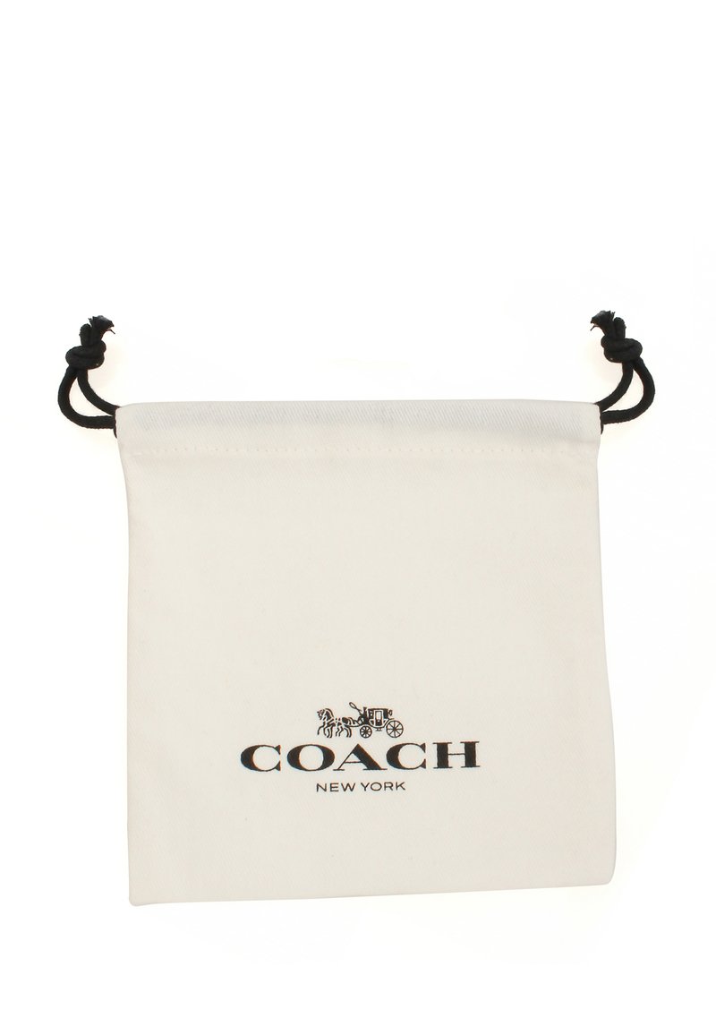 Weißer Baumwollbeutel mit Zugband, der ein bedrucktes schwarzes Logo "COACH NEW YORK" sowie Illustrationen zeigt, designed für die Aufbewahrung oder Präsentation.