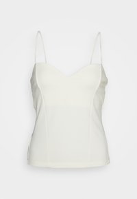 Débardeur blanc avec un décolleté en V, fines bretelles réglables, design ajusté et texture lisse. Les coutures cousues épousent la forme du corps.