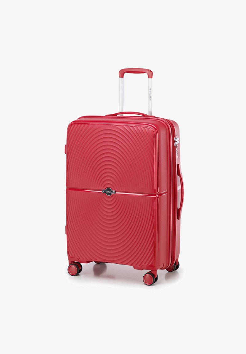 Valise rigide rouge avec un motif en vagues, roues doubles, une poignée télescopique et une poignée de transport supérieure. Logo de la marque visible à l'avant.