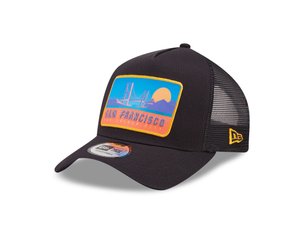 Black trucker cap with a mesh back, featuring a colorful patch of the Golden Gate Bridge, sunset, and text "San Francisco" in yellow.